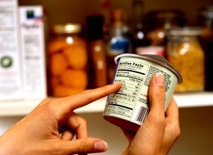 Person Reading Nutrition Label on Packaged Food