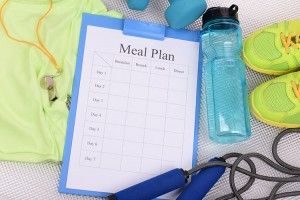 Meal plan and sports equipment top view close-up