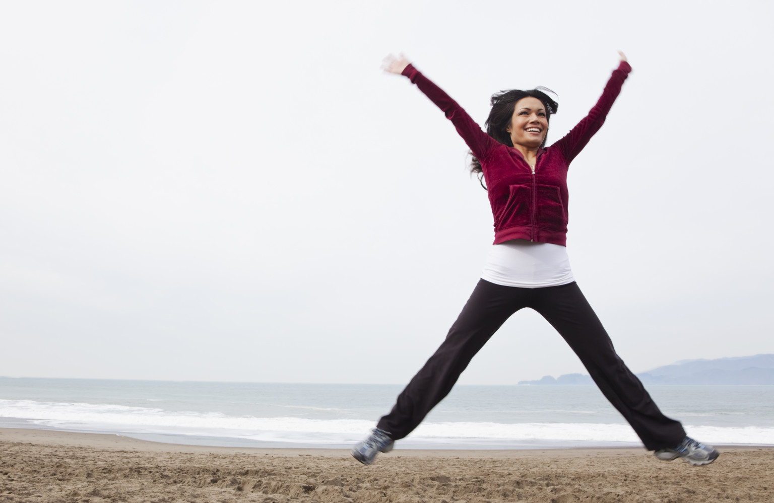 Woman jumping on the beach